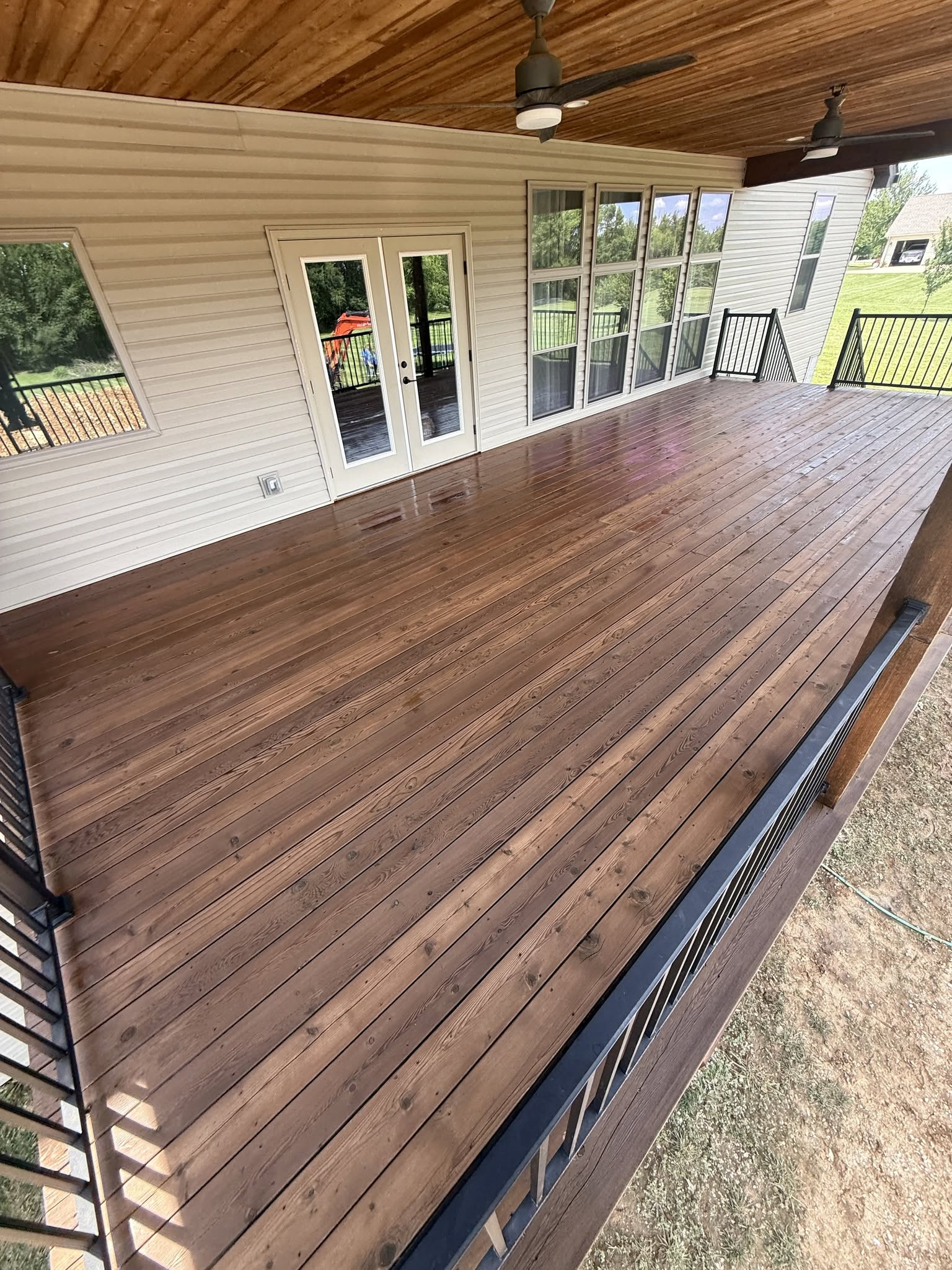 Finished covered deck with ceiling fans and rich stain